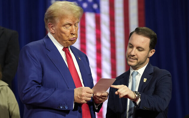 Republican presidential nominee former President Donald Trump reads a note that Justin Caporale brought onto the stage at a campaign town hall at the Greater Philadelphia Expo Center and Fairgrounds, Monday, Oct. 14, 2024, in Oaks, Pa. (AP/Alex Brandon) Republican presidential nominee former President Donald Trump reads a note that Justin Caporale brought onto the stage at a campaign town hall at the Greater Philadelphia Expo Center and Fairgrounds, Monday, Oct. 14, 2024, in Oaks, Pa. (AP/Alex Brandon)