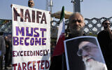 A man holds an anti-Israeli banner as another holds a poster of the Iranian Supreme Leader Ayatollah Ali Khamenei during the funeral ceremony of Islamic Revolutionary Guard Corps Gen. Abbas Nilforushan, who was killed in an Israeli airstrike in Beirut in late September, in Tehran, Oct. 15, 2024. (AP Photo/Vahid Salemi)