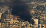 Smoke rise from the Dahiyeh suburb in southern Beirut, Lebanon, following an Israeli airstrike, October 16, 2024. (AP/Hussein Malla)