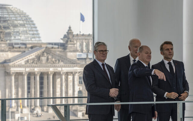 German Chancellor Olaf Scholz, front, gestures as he speaks with British Prime Minister Keir Starmer, left, US President Joe Biden and French President Emmanuel Macron, right, before their Quad meeting at the Chancellery in Berlin, Germany, Friday Oct. 18, 2024. (John Macdougall/Pool Photo via AP) German Chancellor Olaf Scholz, front, gestures as he speaks with British Prime Minister Keir Starmer, left, US President Joe Biden and French President Emmanuel Macron, right, before their Quad meeting at the Chancellery in Berlin, Germany, Friday Oct. 18, 2024. (John Macdougall/Pool Photo via AP)