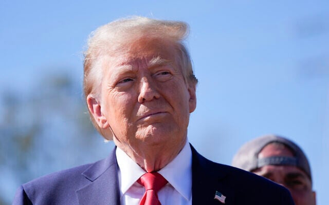 Republican presidential nominee former President Donald Trump listens to others after delivering remarks on the damage and federal response to Hurricane Helene, Monday, Oct. 21, 2024, in Swannanoa, N.C. (AP Photo/Evan Vucci)