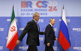 Russian President Vladimir Putin, right, and Iranian President Masoud Pezeshkian walk during their meeting on the sidelines of the BRICS summit in Kazan, Russia, Wednesday, Oct. 23, 2024. (Maxim Shemetov, Pool Photo via AP)