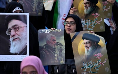 Iranian demonstrators hold posters of Hezbollah terror group leader Hassan Nasrallah, right, Hamas terror group chief Yahya Sinwar, center, and Iranian Supreme Leader Ayatollah Ali Khamenei, in a ceremony commemorating Sinwar and Hashem Safieddine, Nasrallah's intended successor, at Felestin (Palestine) Sq. in Tehran, Iran, Oct. 24, 2024. Nasrallah, Sinwar and Safieddine were all killed by Israeli forces in recent weeks. (AP Photo/Vahid Salemi)