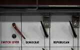 The Democrat and Republican switches are seen on a lever voting machine on display during an open house and talk on the origins of the secret ballot at the New Hampshire State Archives, in Concord, New Hampshire, October 24, 2024. (Charles Krupa/AP)