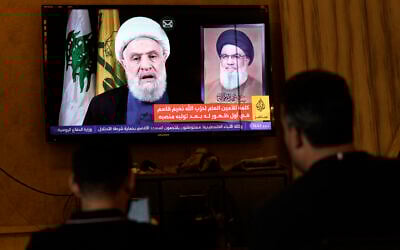 People watch Hezbollah's newly named leader Naim Qassem delivering a televised speech, in the southern port city of Sidon, Lebanon, October 30, 2024. (AP Photo/Bilal Hussein)