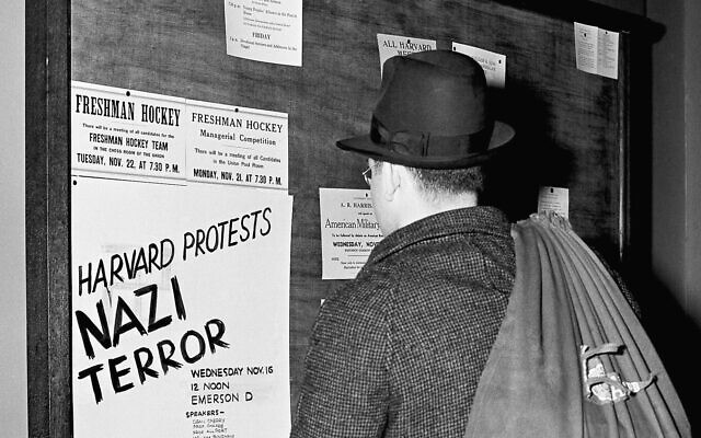 A student reads a bulletin board announcement of a meeting November 16, 1938, at Harvard University, Cambridge, Massachusetts, which met to denounce persecution of Jews in Nazi Germany. (AP Photo/Fox)