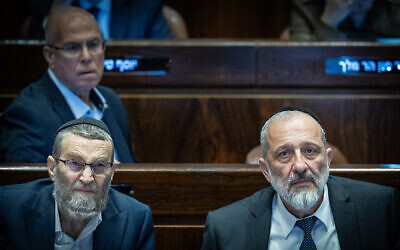MK Moshe Gafni, left, with MK Aryeh Deri at the Knesset in Jerusalem, March 13, 2024. (Yonatan Sindel/Flash90)