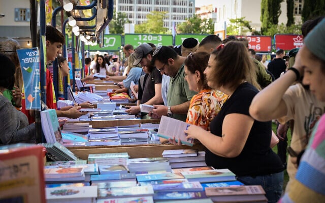 Illustrative: Israelis attend the annual Hebrew Book Week in Tel Aviv on June 18, 2023. (Avshalom Sassoni/Flash90) Illustrative: Israelis attend the annual Hebrew Book Week in Tel Aviv on June 18, 2023. (Avshalom Sassoni/Flash90)