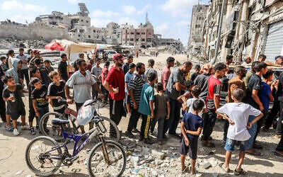 Palestinians line up to buy bread at a bakery run by the UN World Food Programme and UNRWA in in Khan Younis, in the southern Gaza Strip, on September 8, 2024. (Abed Rahim Khatib/Flash90) Palestinians line up to buy bread at a bakery run by the UN World Food Programme and UNRWA in in Khan Younis, in the southern Gaza Strip, on September 8, 2024. (Abed Rahim Khatib/Flash90)