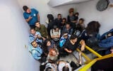 Israelis take cover inside a bomb shelter at Ben Gurion airport as a siren alert is sounded in Tel Aviv, October 1, 2024 (Photo by Dor Pazuelo/Flash90)