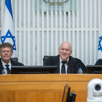 Outgoing Acting Supreme Court President Uzi Vogelman with incoming Acting Supreme Court President Isaac Amit (L) and Justice Noam Sohlberg (R) at a farewell ceremony for Vogelman at the Supreme Court in Jerusalem, October 1, 2024. (Oren Ben Hakoon/Pool)