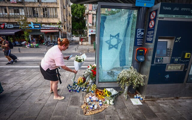 People lay flowers at the site of a deadly terror shooting attack the night before in Jaffa, October 2, 2024. (Dor Pazuelo/Flash90) People lay flowers at the site of a deadly terror shooting attack the night before in Jaffa, October 2, 2024. (Dor Pazuelo/Flash90)