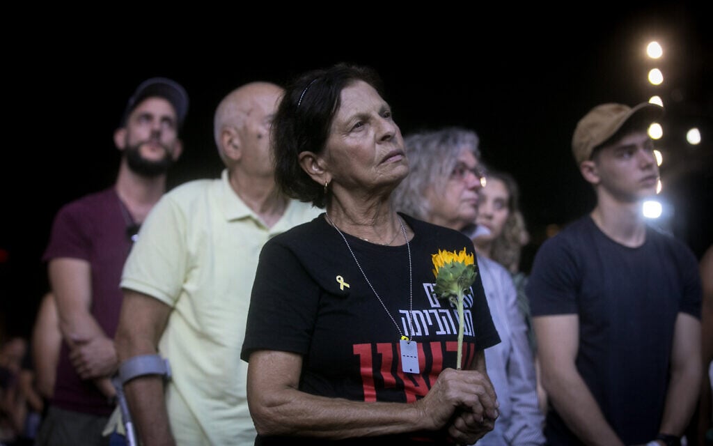 A woman pauses at the October 7 memorial ceremony at Yarkon Park in Tel Aviv, marking one year since the Hamas massacre, October 7, 2024. (Miriam Alster/Flash90) A woman pauses at the October 7 memorial ceremony at Yarkon Park in Tel Aviv, marking one year since the Hamas massacre, October 7, 2024. (Miriam Alster/Flash90)
