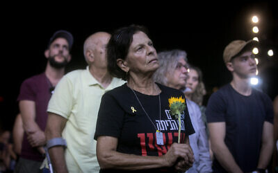 A woman pauses at the October 7 memorial ceremony at Yarkon Park in Tel Aviv, marking one year since the Hamas massacre, October 7, 2024. (Miriam Alster/Flash90)