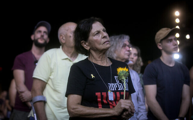 A woman pauses at the October 7 memorial ceremony at Yarkon Park in Tel Aviv, marking one year since the Hamas massacre, October 7, 2024. (Miriam Alster/Flash90)