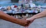 IMAGE: Israelis hold hands at Dizengoff Square in Tel Aviv, next to photographs of Israelis killed in the October 7 massacre, on the one-year anniversary of the Hamas attack, October 7, 2024. (Tomer Neubergi/Flash90)