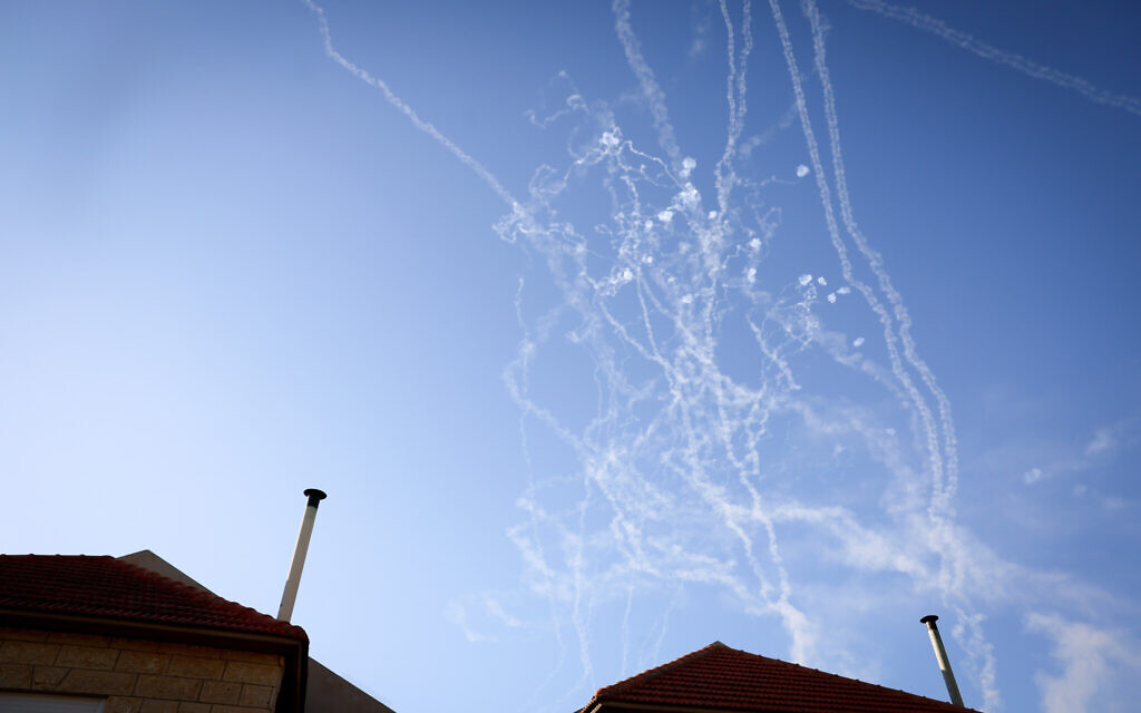 Smoke trails are seen as rockets launched from Lebanon into northern Israel are intercepted over Safed, October 9, 2024. (David Cohen/Flash90)