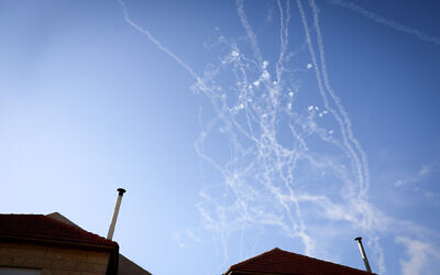 Smoke trails are seen as rockets launched from Lebanon into northern Israel are intercepted over Safed, October 9, 2024. (David Cohen/Flash90)