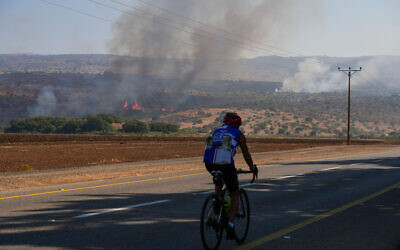 Smoke rises from a fire that broke out as a result of rockets fired from Lebanon near Kibbutz Shamir, in the Upper Galilee, October 11, 2024 (Ayal Margolin/Flash90)