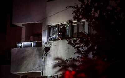 Security and rescue forces at the site where a drone fired from Lebanon caused damage to a building in Herzliya, October 11, 2024. (Tal Gal/Flash90)