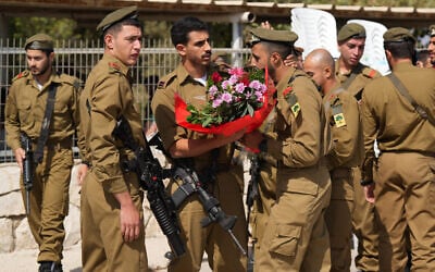 Soldiers gather before the funeral of IDF Sgt. Yosef Hieb at the cemetery in Tuba Zangariya, northern Israel, on October 14, 2024, killed in a Hezbollah drone strike. (Ayal Margolin/Flash90)