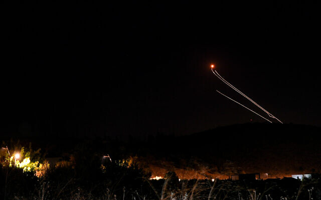 An anti-missile system fires interception missiles at rockets from Lebanon, as seen from the northern city of Kiryat Shmona, October 20, 2024. (Ayal Margolin/Flash90)