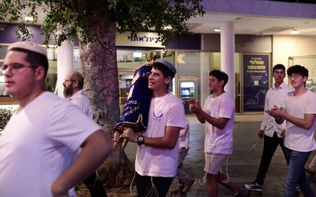 Jewish men carry Torah scrolls as they dance during Simhat Torah celebrations in Tel Aviv, on October 24, 2024. (Tomer Neuberg/Flash90) Jewish men carry Torah scrolls as they dance during Simhat Torah celebrations in Tel Aviv, on October 24, 2024. (Tomer Neuberg/Flash90)
