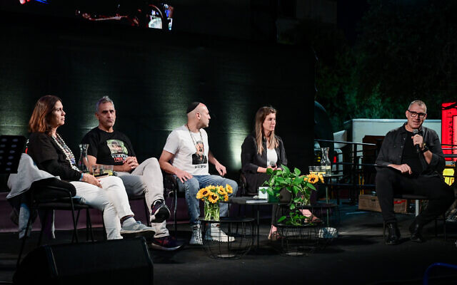 Bereaved family members Yael Adar (from left), Michel Ilouz, Roy Baruch and Bar Godard speak to journalist Ben Shani (right), during a ceremony at Hostages Square on October 27, 2024. (Avshalom Sassoni/Flash90)