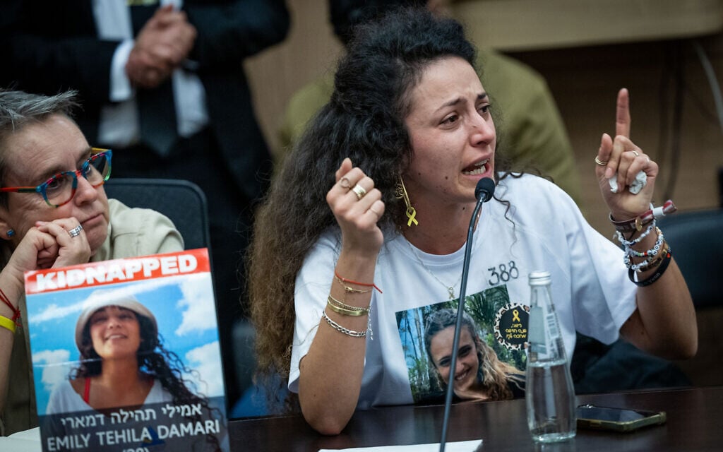 Yarden Gonen, sister of hostage Romi, attends a meeting of the Knesset Committee on the Status of Women and Gender Equality, with Mandy Damari, mother of hostage Emily, to her left, in Jerusalem on October 28, 2024 (Yonatan Sindel/Flash90)