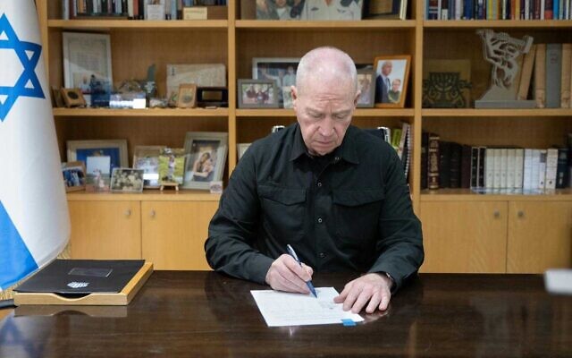 Defense Minister Yoav Gallant signs an order declaring Hezbollah's grey-market bank Al-Qard Al-Hassan a terrorist organization on October 21, 2024 (Shira Keinan/Defense Ministry) Defense Minister Yoav Gallant signs an order declaring Hezbollah's grey-market bank Al-Qard Al-Hassan a terrorist organization on October 21, 2024 (Shira Keinan/Defense Ministry)