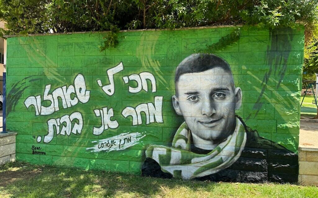 A portrait of hostage Matan Angrest reads, 'Wait for me to come back, tomorrow I'll be home,' painted by graffiti artist Benzi Brofman (Courtesy)