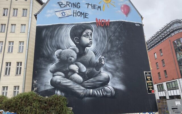 Graffiti artist Benzi Brofman painting one of his October 7 murals, this one in Germany (Courtesy Ruthe Zuntz)