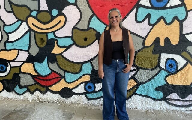 Kibbutz Yad Mordechai member Limor Livne put together 'And the Sun Did Not Stand Still,' an exhibit of Israeli artworks that opened October 8, 2024, to help bring her community and the Gaza envelope back to life (Jessica Steinberg/Times of Israel)