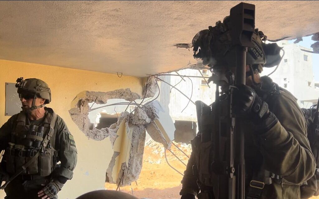 91st Division commander Brig. Gen. Shai Klepper (L) in southern Lebanon points out  the Hezbollah weapons cache his troops uncovered, October 10, 2024. (Lazar Berman/Times of Israel)