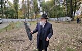 Rabbi Jonathan Markovitch holds a fragment of a Russian drone that damaged the Chabad-run Perlina school in Kyiv, Ukraine, October 30, 2024. (Courtesy Kyiv Jewish Community via JTA)
