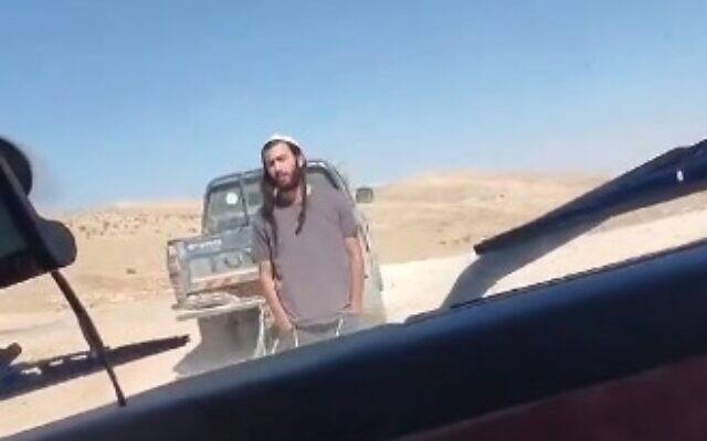 An Israeli settler is filmed blocking a Palestinian driver from proceeding down a road in the southern West Bank on October 23, 2024. (Screen capture/X)