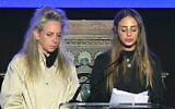 Freed hostage Mia Schem, right, speaks at an event marking the Hebrew calendar anniversary of Hamas's onslaught of October 7, 2023, as her mother Keren Schem stand by her side, at Israel's consulate in New York, October 28, 2024. (Screen capture: Ynet, used in accordance with Clause 27a of the Copyright Law)