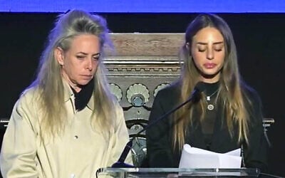 Freed hostage Mia Schem, right, speaks at an event marking the Hebrew calendar anniversary of Hamas's onslaught of October 7, 2023, as her mother Keren Schem stand by her side, at Israel's consulate in New York, October 28, 2024. (Screen capture: Ynet, used in accordance with Clause 27a of the Copyright Law) Freed hostage Mia Schem, right, speaks at an event marking the Hebrew calendar anniversary of Hamas's onslaught of October 7, 2023, as her mother Keren Schem stand by her side, at Israel's consulate in New York, October 28, 2024. (Screen capture: Ynet, used in accordance with Clause 27a of the Copyright Law)