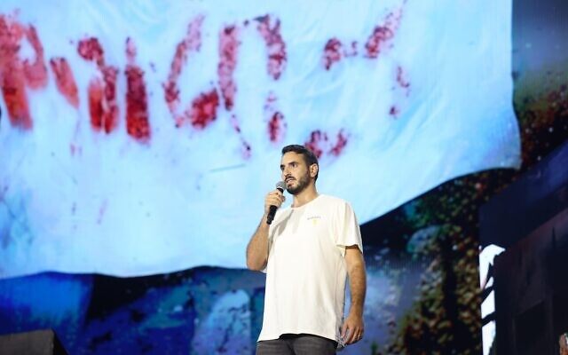 Jonathan Shamriz, bereaved brother of hostage Alon Shamriz who was killed by mistake by the IDF in Gaza on December 15, 2023, speaks at the alternative Bereaved Families Ceremony on October 7, 2024 at Tel Aviv's Yarkon Park (Courtesy)