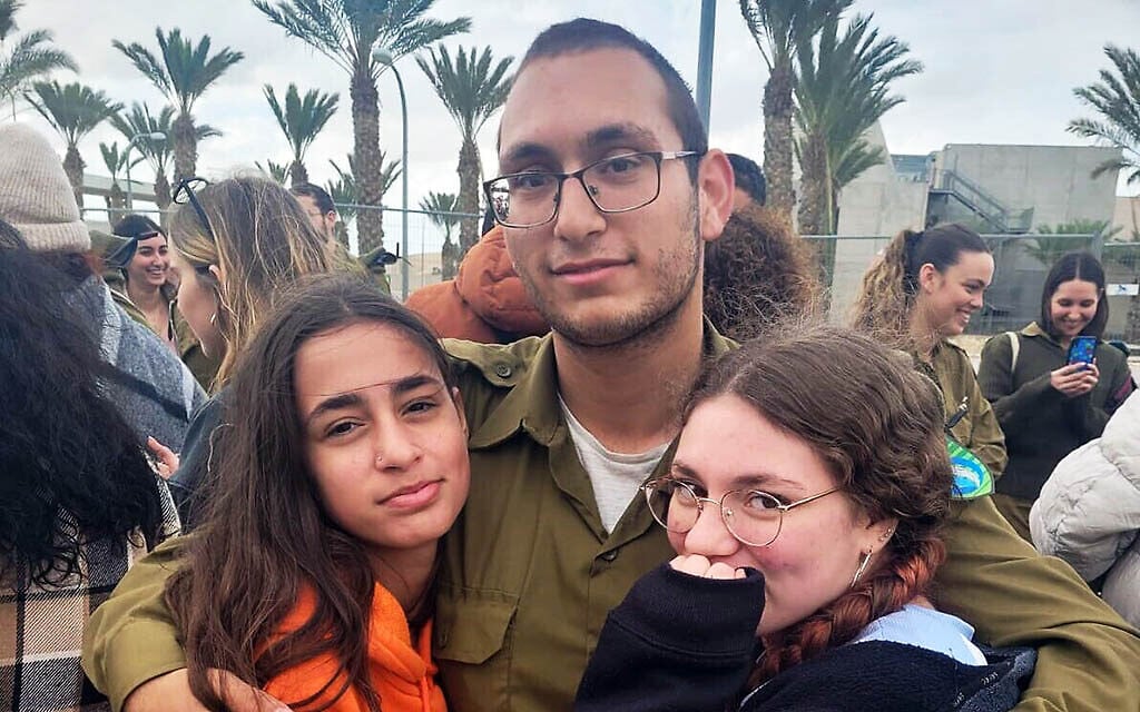 Tamir Nimrodi, center, taken hostage from his army base on October 7, 2023, with his two younger sisters, Mika, left and Amit (Courtesy) Tamir Nimrodi, center, taken hostage from his army base on October 7, 2023, with his two younger sisters, Mika, left and Amit (Courtesy)