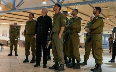 Defense Minister Yoav Gallant visits a Golani base in Binyamina that was hit by a Hezbollah drone strike the previous day, on October 14, 2024. (Ariel Hermoni/Defense Ministry)