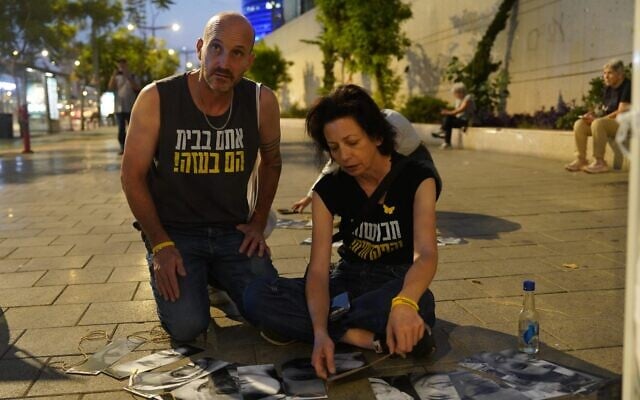 Relatives of hostages held in Gaza construct a Sukkah outside the Kirya Defense Ministry headquarters in Tel Aviv, October 16, 2024. (Pro-Democracy Protest Movement/Dana Reany) Relatives of hostages held in Gaza construct a Sukkah outside the Kirya Defense Ministry headquarters in Tel Aviv, October 16, 2024. (Pro-Democracy Protest Movement/Dana Reany)