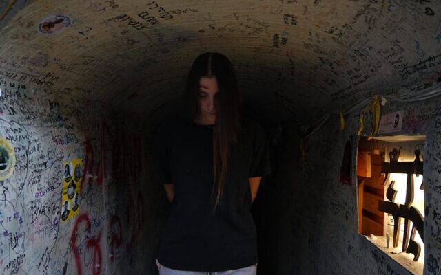 This handout photo from protest organizers shows a woman dressed like hostage Naama Levy standing in a display meant to resemble the Hamas tunnels in Gaza, October 19, 2024. (Lior Segev/Pro-Democracy Protest Movement)