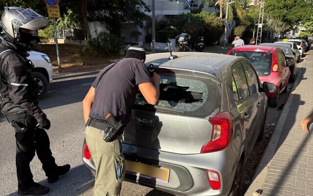 A car in Herzliya damaged by falling shrapnel following a rocket interception, October 23, 2024. (Israel Police) A car in Herzliya damaged by falling shrapnel following a rocket interception, October 23, 2024. (Israel Police)