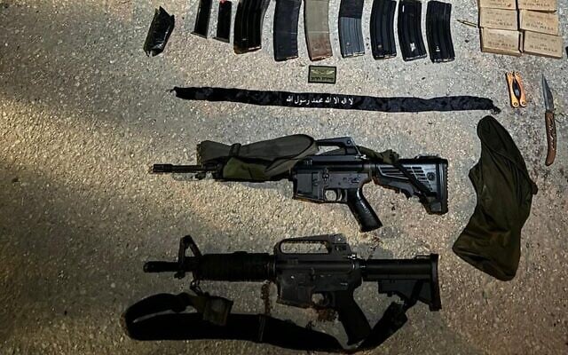 A handout photo released by the IDF on October 11, 2024, shows what the Israeli military says are guns and other items found on a pair of terrorists killed in an airstrike near Tulkarem a day earlier. (IDF Spokesperson)