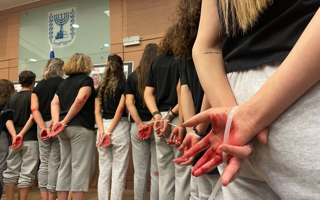 Women dressed as hostage Naama Levy highlight the abuse suffered by those held captive in Gaza, at a meeting of the Knesset Committee on the Status of Women and Gender Equality, Jerusalem, October 28, 2024 (Sam Sokol/Times of Israel)