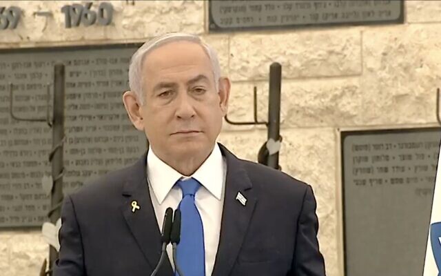 Prime Minister Benjamin Netanyahu pauses as he is interrupted by hecklers at a ceremony to honor civilian victims of October 7 and the subsequent war, October 27, 2024 (Screen grab)
