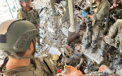 IDF troops stand over the body of Hamas leader Yahya Sinwar in Gaza on October 17, 2024. (Courtesy)