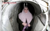 A screenshot of video released by the IDF on October 19, 2024, shows Hamas leader Yahya Sinwar's wife, Samar Muhammad Abu Zamar, holding a handbag, escaping into a tunnel with him and their children on the night before the Gaza-ruling terror group's October 7, 2023, onslaught against Israel. (Screen capture; used in accordance with Clause 27a of the Copyright Law)
