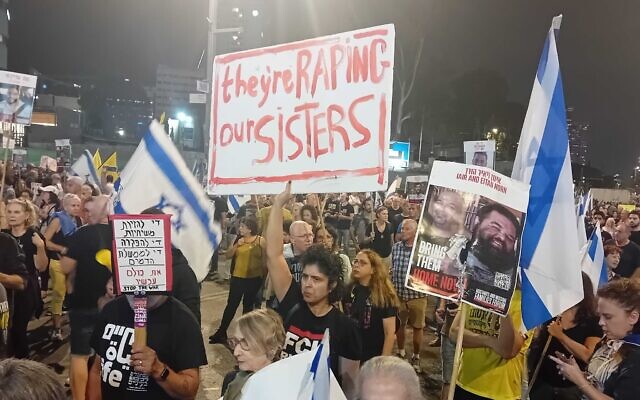 A woman holds a sign reading 'they're raping our sisters' at a pro-hostage deal protest on Tel Aviv's Begin Street, November 2, 2024. (Noam Lehmann/The Times of Israel) A woman holds a sign reading 'they're raping our sisters' at a pro-hostage deal protest on Tel Aviv's Begin Street, November 2, 2024. (Noam Lehmann/The Times of Israel)